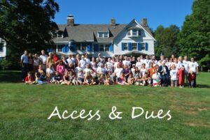 Photo of large group of people in front of a historic house